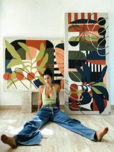Argentine artist Vera Farelo with her colorful paintings in Tulum, Mexico
